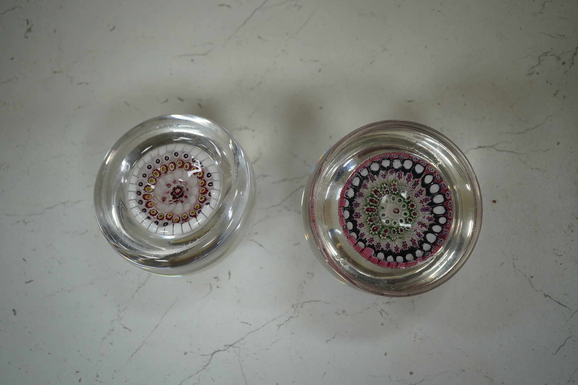 Two Victorian English millefiori glass paperweights, 7cm tall. Condition - fair to good